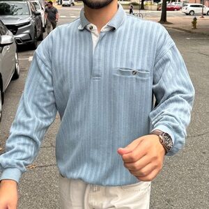 Light blue sweater with lined pattern going down the middle size L fits like a M